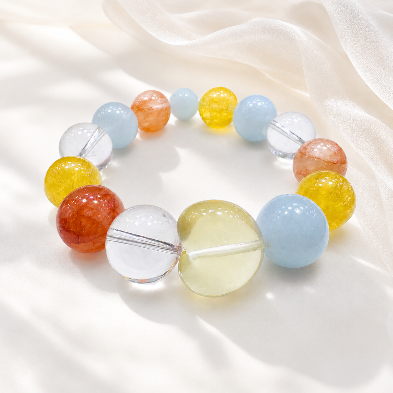 Carnelian aquamarine citrine and clear quartz stretch bracelet on white silk flatlay
