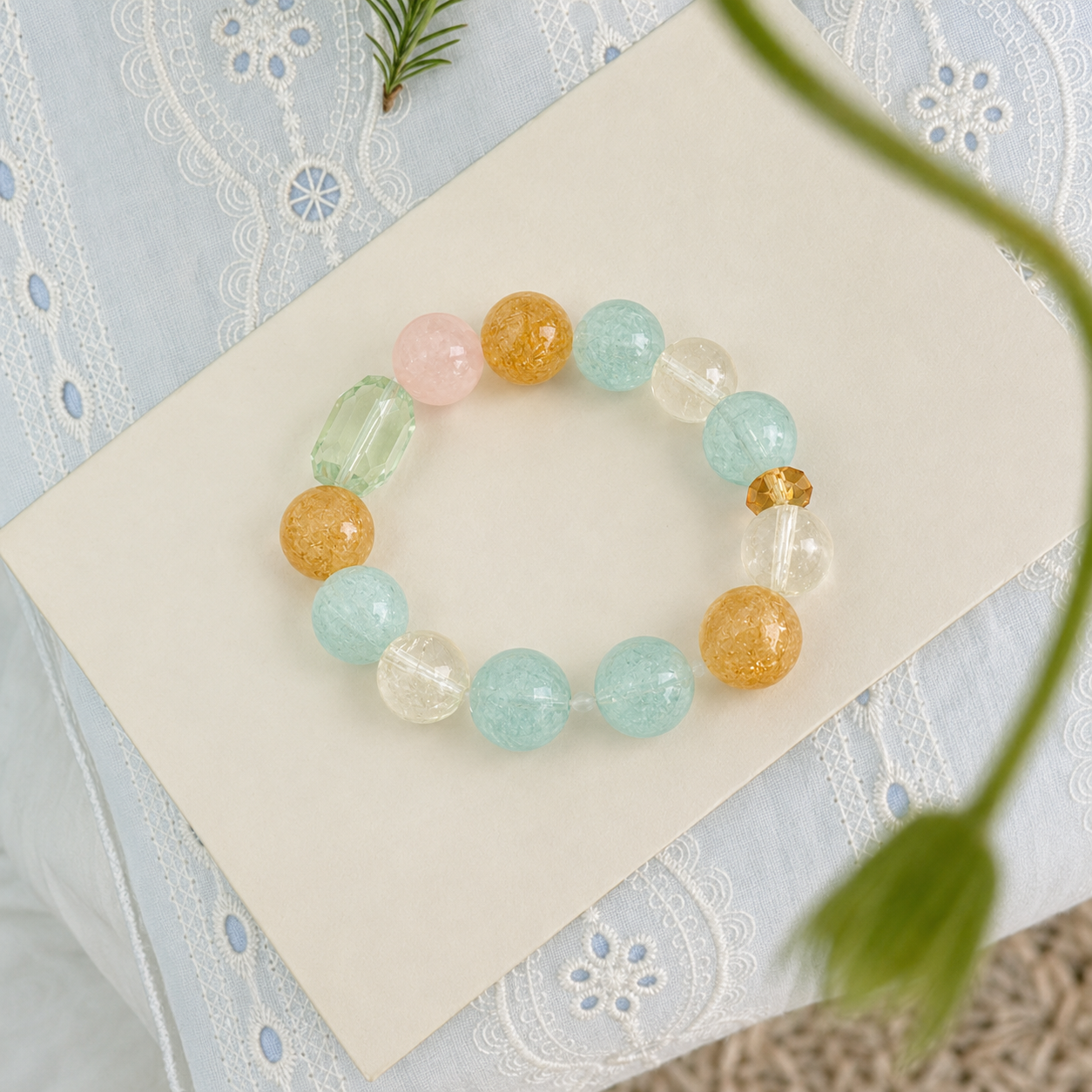 Citrine and crystal stretch bracelet on cream card with lace fabric and botanical styling